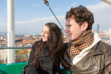 Young Couple having a Ride on a Ferris Wheel