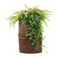 Composition of artificial flowers in old wooden barrel isolated