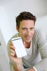 Man showing smartphone to camera