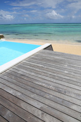 Fototapeta na wymiar Beautiful view of infinity pool with wooden deck