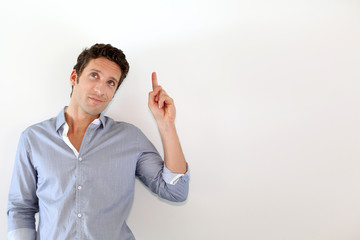 Young man pointing at message on white background