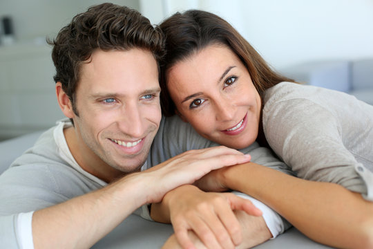 Portrait of sweet couple sitting in sofa