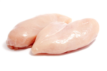 raw chicken breasts on white