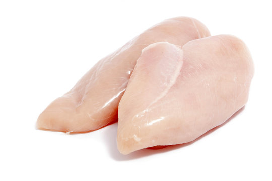 raw chicken breasts on white