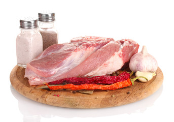 Raw meat and vegetables on a wooden board isolated on whitе