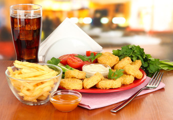 Fried chicken nuggets with vegetables,cola,french fries and