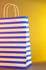 Fototapeta premium Striped bag on yellow background