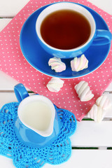 Beautiful tea composition on wooden picnic table close-up