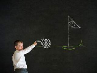 Writing boy business man with chalk golf ball flag green