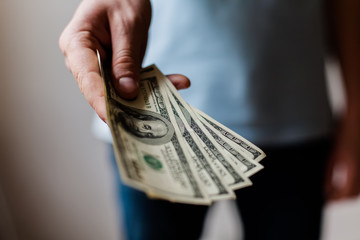 Man holding American dollars in  hands