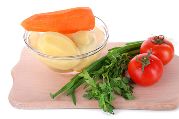 Peeled vegetables in bowl isolated on white