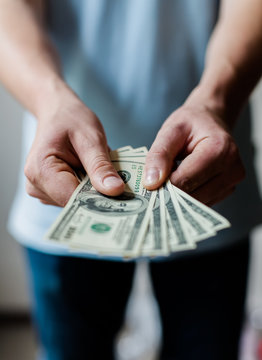 Man holding American dollars in  hands