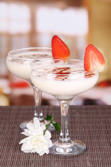 Fruit smoothies on table on window background