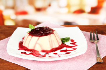 Panna Cotta with raspberry sauce, on bright background
