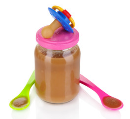 Baby food with baby supplies isolated on white
