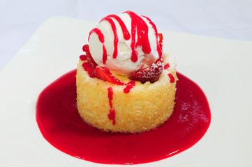 Cupcake topped with strawberry slices and ice cream scoop