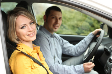 Portrait of young beautiful  couple sitting in the car