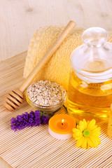 Fragrant honey spa with oils and honey on wooden table close-up