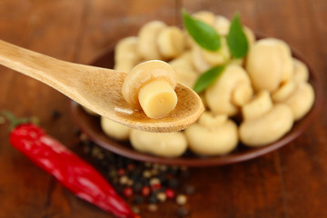 Mushrooms on plate, on wooden background