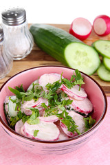 Vitamin vegetable salad in bowl with ingredients isolated