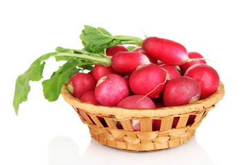 Small garden radish in wicker basket isolated on white