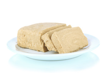 Tasty halva on plate isolated on white