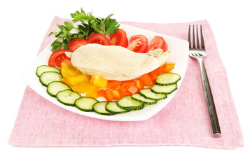 Boiled chicken breast on plate with vegetables close up