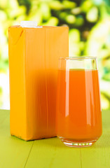 Juice pack on table on bright background