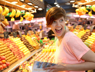 Girl with traveler book in la Boqueria market, Barcelona