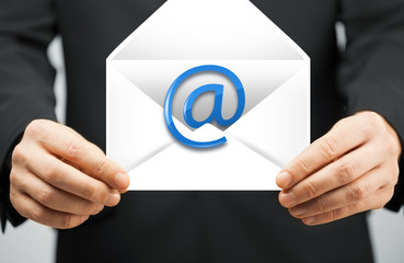 man in suit holding envelope with email sign