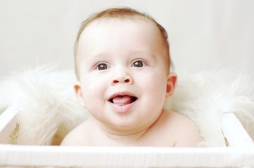 happy baby in white basket