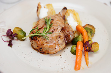 Fried rack of lamb on beige porcelain plate