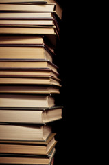 Stack of old books on black