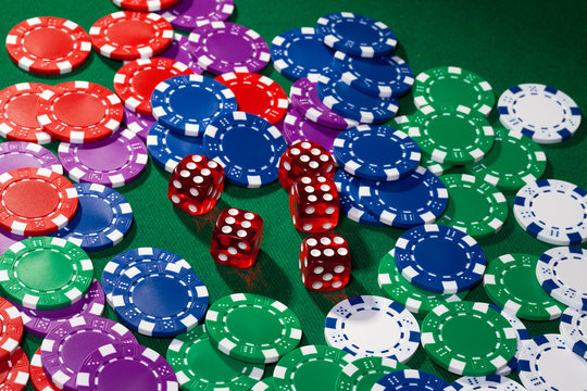 Colorful poker chips and red dice