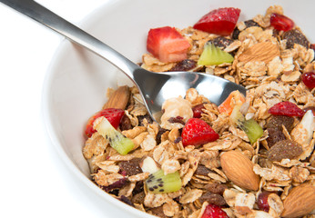 Fototapeta premium Muesli cereals bowl and spoon with almond, pine nuts