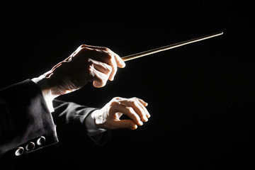 Orchestra conductor hands baton