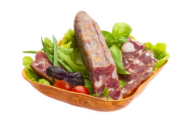 Ripe salami with salad, basil, onion and tomato
