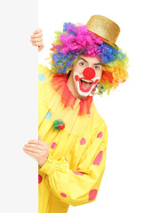 Obraz na płótnie Canvas Funny circus clown holding a blank panel