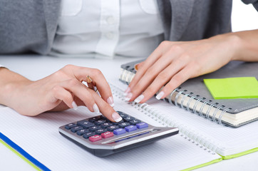 Hands working on the calculator