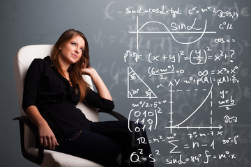 Beautiful school girl thinking about complex mathematical signs