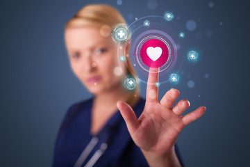 Young nurse pressing modern medical type of buttons