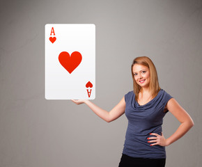 Beautifu woman holding a red heart ace