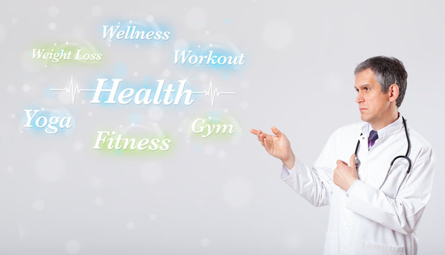Clinical doctor pointing to health and fitness collection of wor