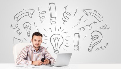 Young businessman brainstorming with drawn arrows and symbols