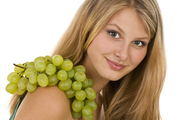 Long-haired beautiful blonde with grapes .