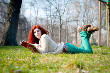 beautiful red head young woman reading book