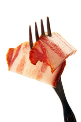 a slice of ham on a steel fork.