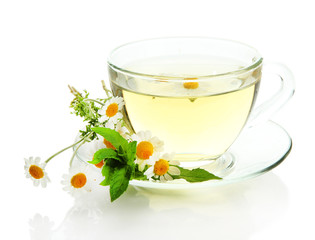 Cup of herbal tea with wild camomiles and mint, isolated