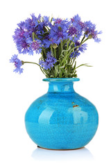 Beautiful bouquet of cornflowers in vase, isolated on white
