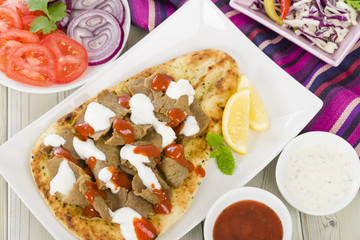 Donner Meat on Naan - Slices of donner meat on a flatbread